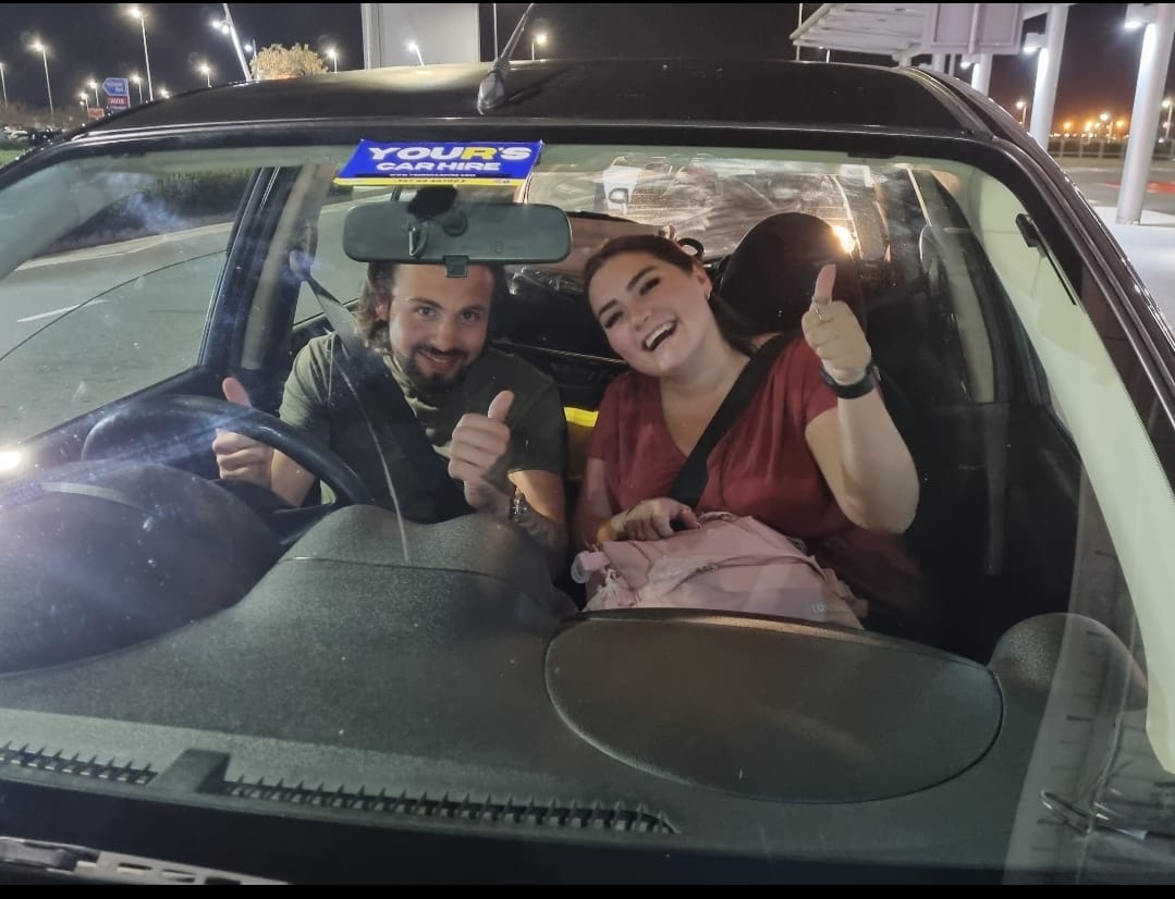 Customers giving thumbs up in car